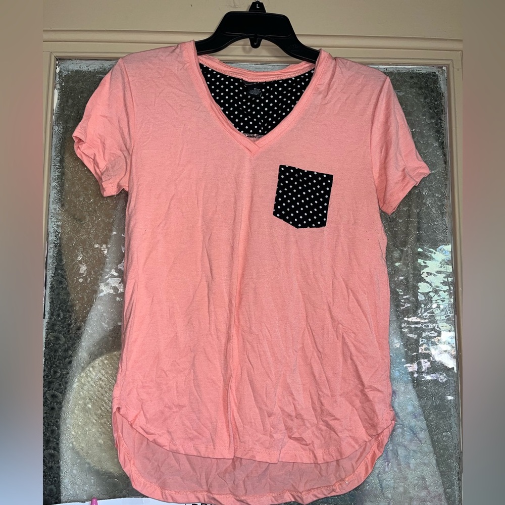 Pink shirt with black and white polka dot pocket